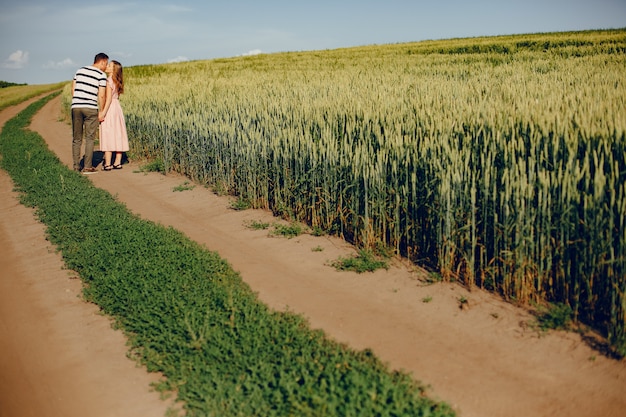 Free photo beautiful couple spend time on a summer field