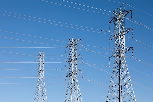 Free Photo beautiful shot of electric poles under a blue sky