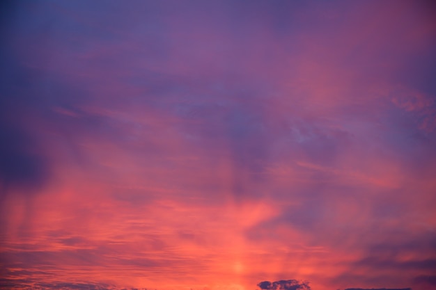 Free photo beautiful shot of pink clouds in a clear blue sky with a scenery of sunrise