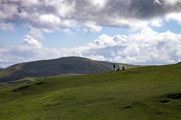 Free Photo beautiful shot of travelers enjoying the view of clare island, county mayo in ireland