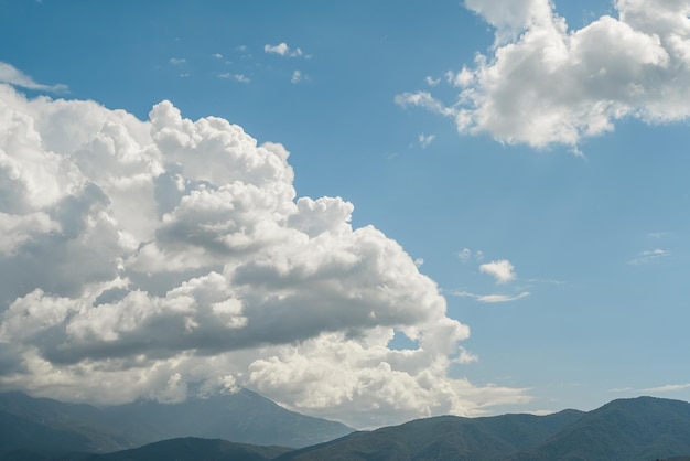 Free photo beautiful view of the mountains and cumulus clouds on the aegean sea travel time postcard for background or screensaver