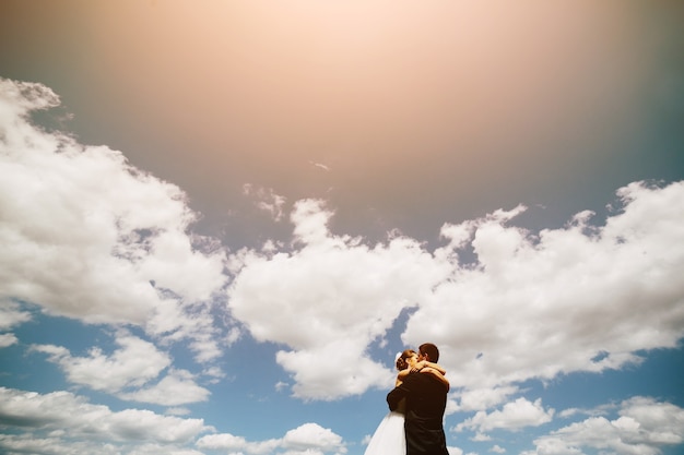 Free Photo beautiful wedding couple on the background of blue sky