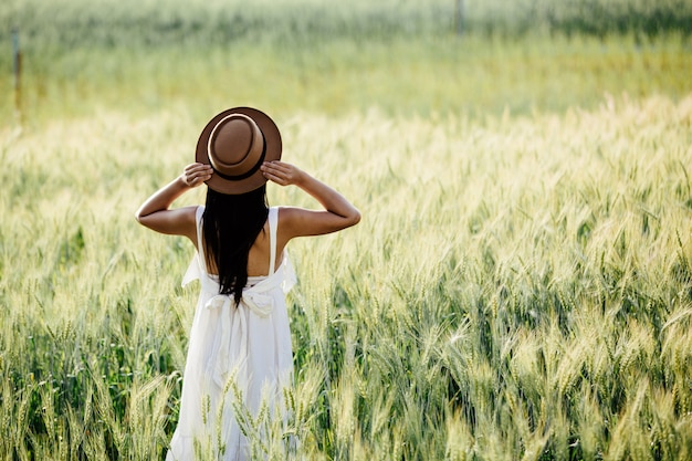 Free photo beautiful woman enjoying in barley fields.