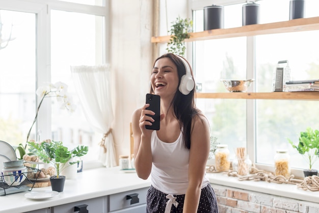 Beautiful woman enjoying music in the morning