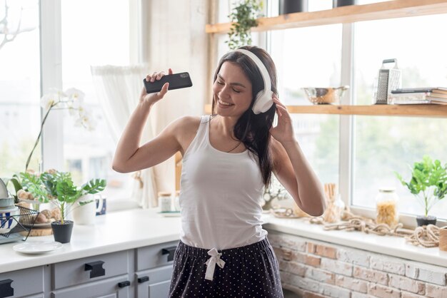 Beautiful woman listening to music at home