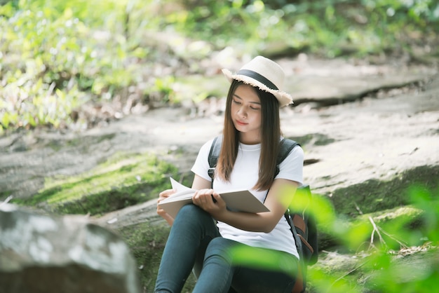 Free photo beautiful woman reading book at nature