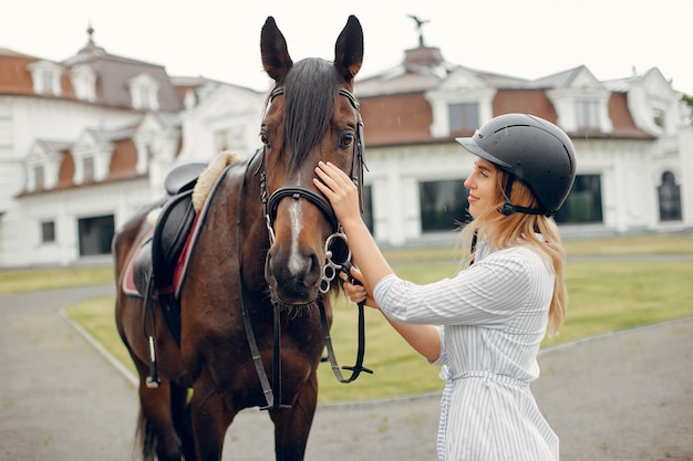 Free photo beautiful woman standing with a horse