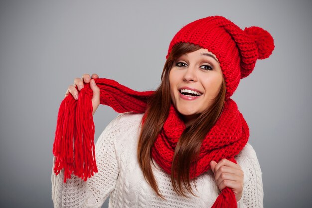 Beautiful young woman wearing red hat and scarf
