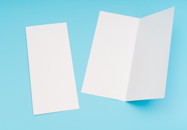 Free Photo bifold white template paper on blue background .