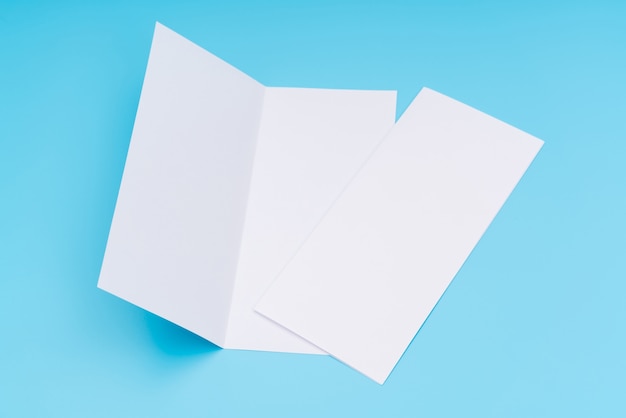 Free Photo bifold white template paper on blue background .