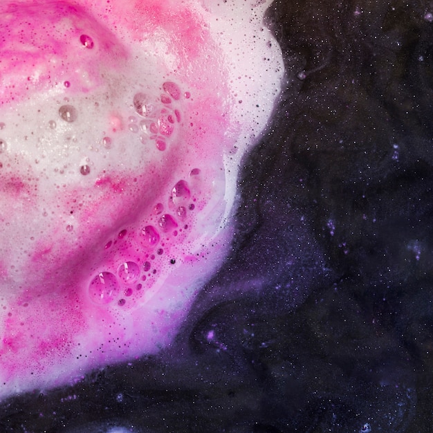 Free Photo black liquid with pink spume 