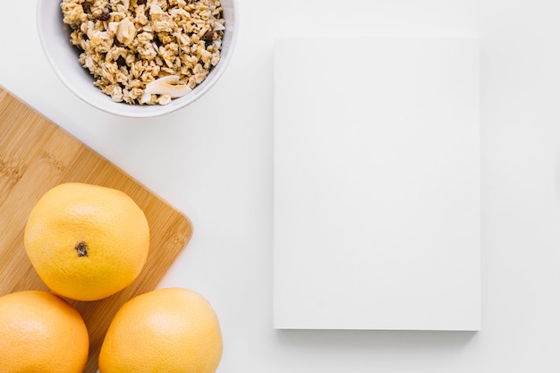 Free Photo book cover mockup with oranges and cereals