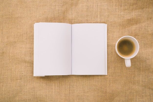 Free Photo book mockup on cloth with coffee