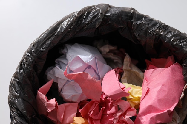 Free Photo bucket with garbage bag and papers on white background close up