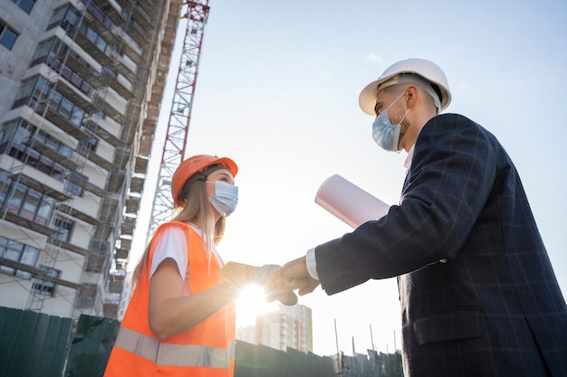 Free Photo building and construction worker on the site with architect