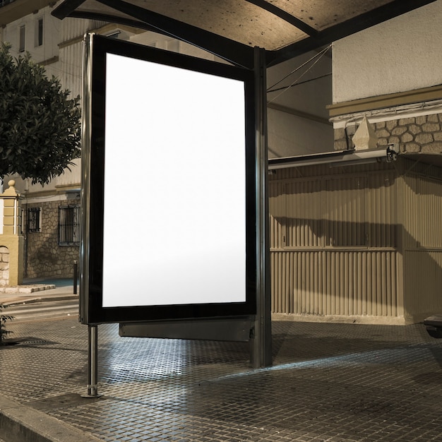 Free photo bus station with illuminated blank banner on a street