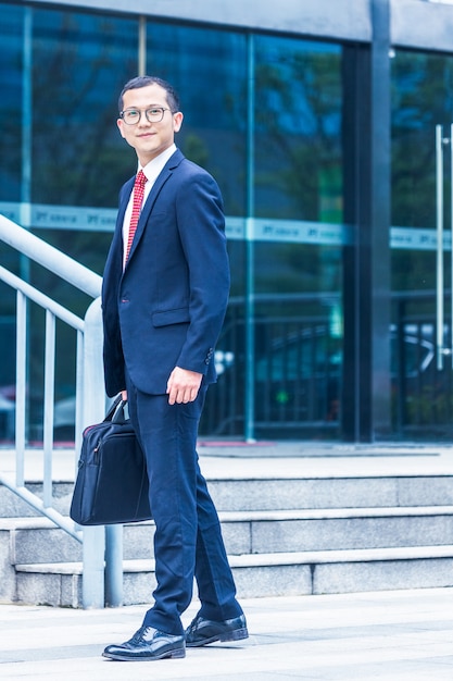 Free Photo business men carry laptops to the office building