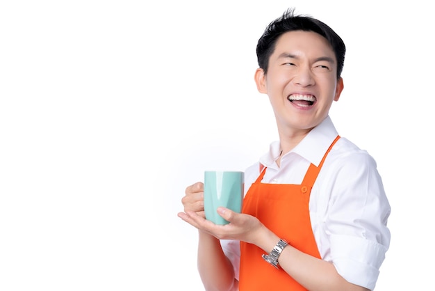 Free photo business owner communication ideas concept with asian attractive male orange apron hand hold color hot drink smile and happiness hand gesture pose joyful moment