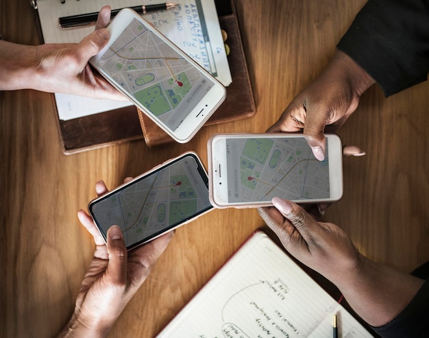 Free photo business people using maps on phones