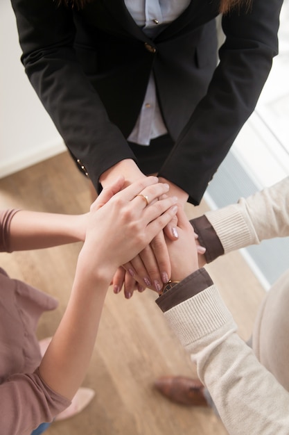 Free Photo business teamwork concept, top view of hands joined together, vertical