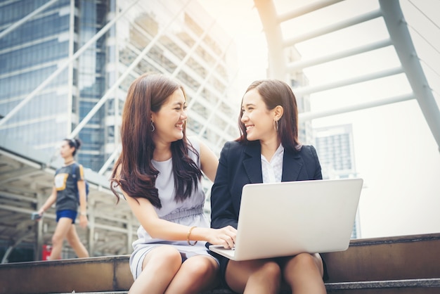 Free photo business woman talking or conversation while working sitting  outdoor.