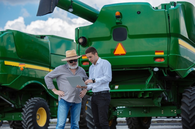 Free Photo businessman and farmer with tractors