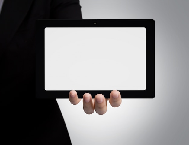 Free Photo businessman's hand showing a blank tablet