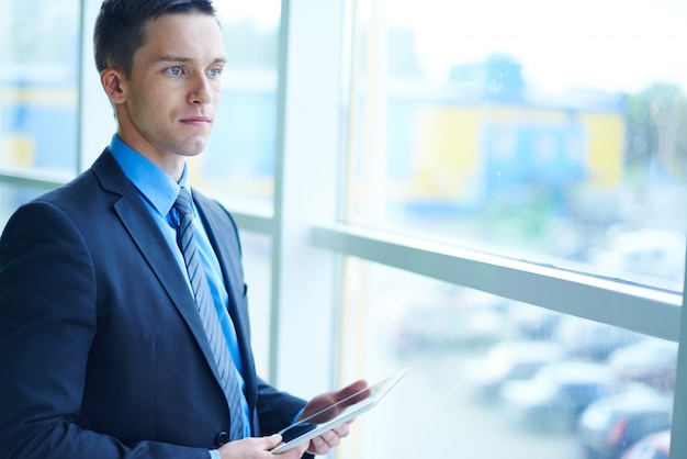 Free photo businessman staring through the window