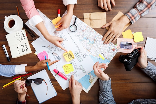 Free photo businessmen hands on wooden table with documents and drafts