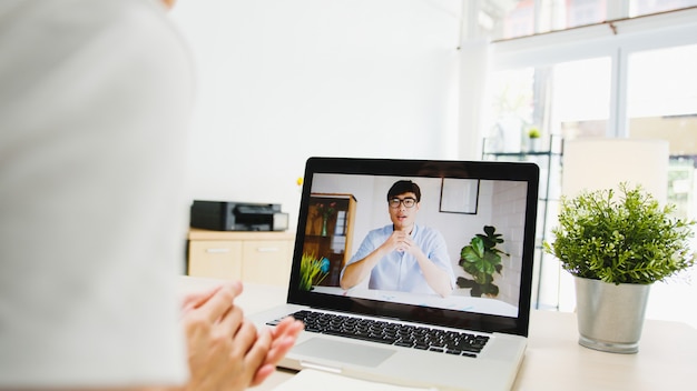 Free Photo businesswoman using laptop talk to colleagues about plan in video call meeting while working from home at living room.