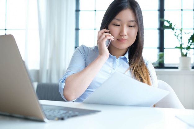 Free photo businesswoman using a smartphone