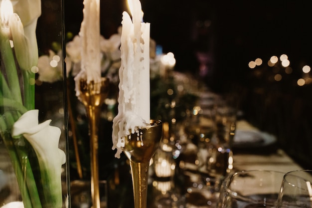 Free Photo candle in golden candlestick on wedding table