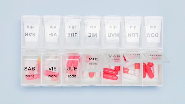 Free photo capsules in pill organizer top view