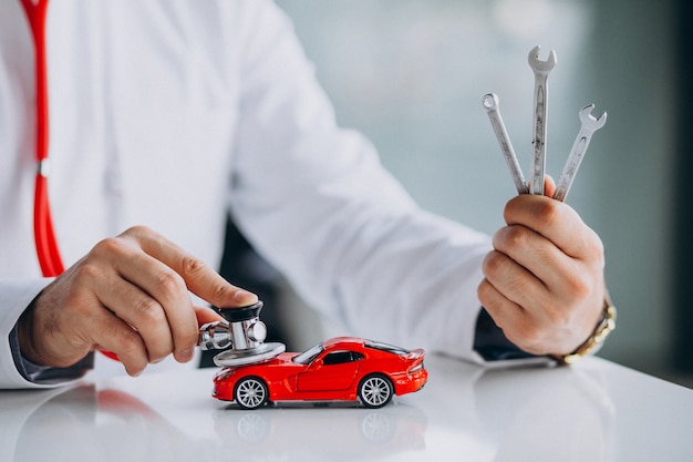 Free Photo car technician with stethoscope in a car showroom