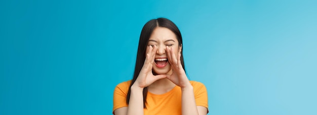 Free Photo carefree asian enthusiastic girl shouting long distance calling friend breaking free emotions yellin