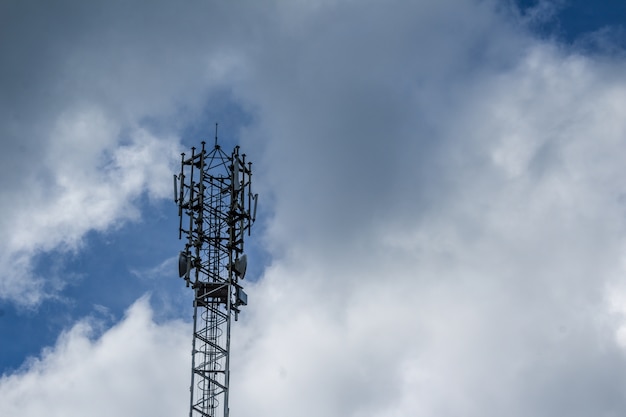 Free photo cellphone tower with clouds in the background