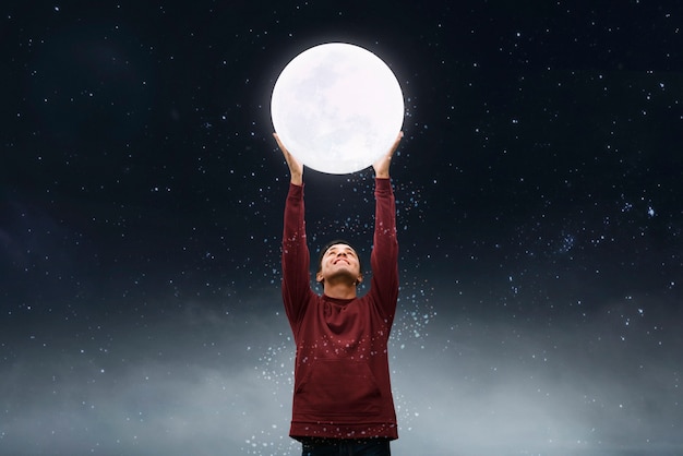 Free Photo child holding moon