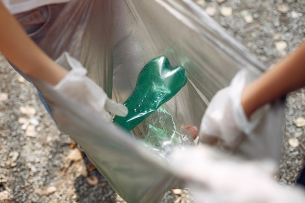 Free Photo children collects garbage in garbage bags in park