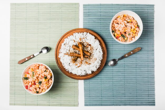 Chinese fried and steam rice with cinnamon sticks on placemat