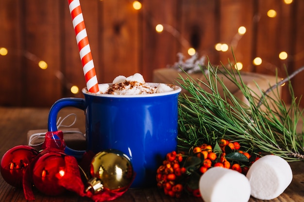 Christmas composition with straw in mug