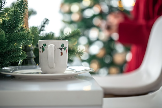 Christmas cup in the kitchen on a blurred background with bokeh, copy space.