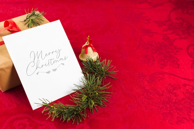 Free Photo christmas greeting card on red table