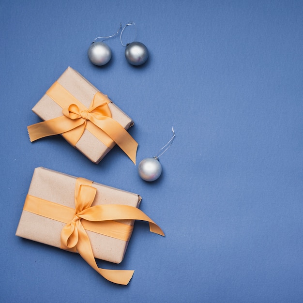 Christmas presents with silver globes on blue background