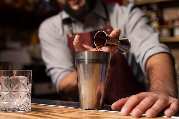 Free photo close up on bartender and cocktail shaker