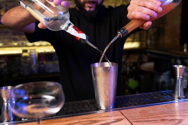 Free photo close up on bartender and cocktail shaker