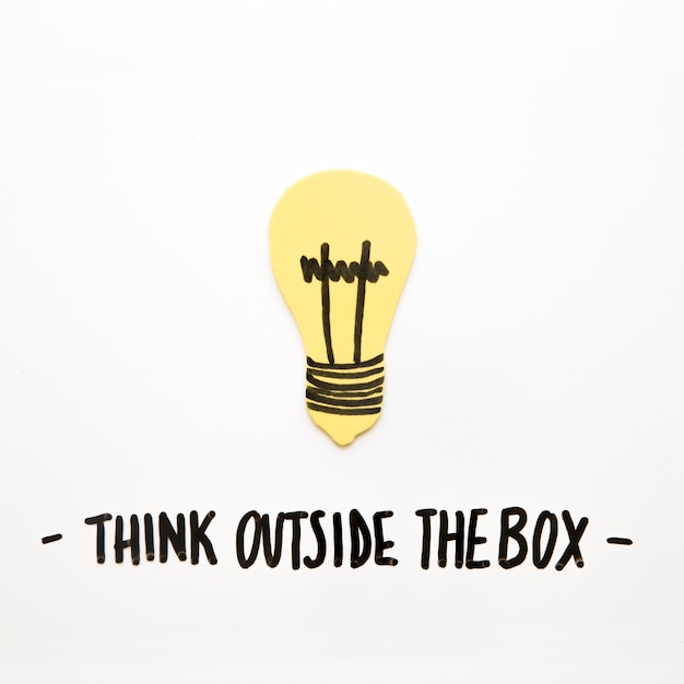 Free photo close-up of bulb with think outside the box text on white background