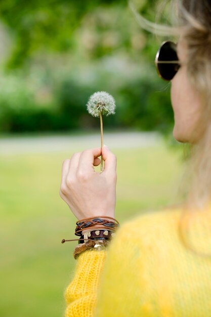 Close-up girl holding dandelion
