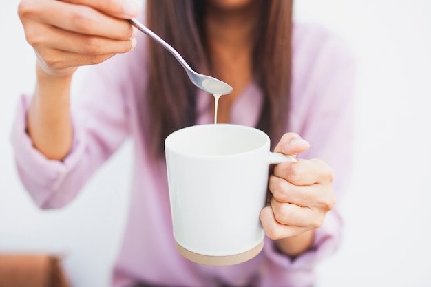 Free Photo close-up of girl with cup and spoon