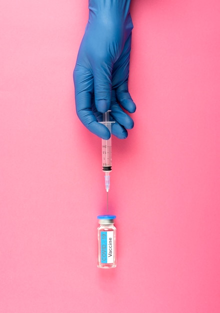 Free photo close up hand with glove holding syringe