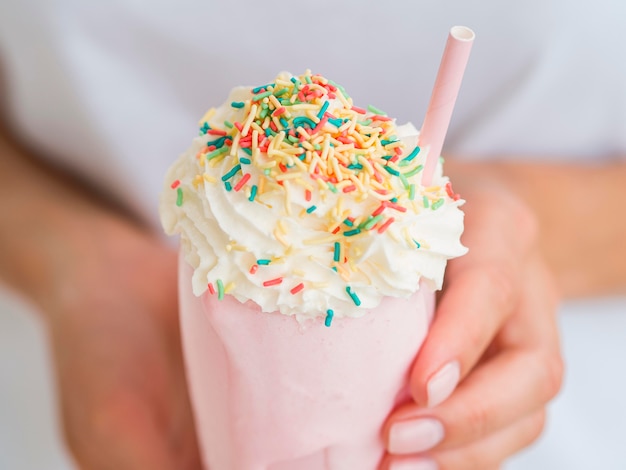 Free Photo close-up hands holding milkshake